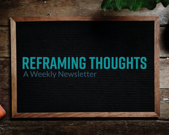 A black board with the words reframing thoughts written on it.