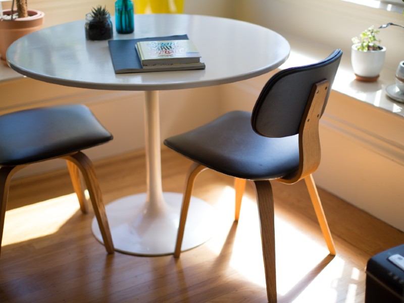 A table and chair with books on the top of it